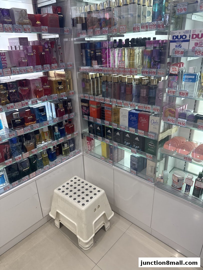 A wide selection of perfumes and beauty products displayed on shelves in a retail store.