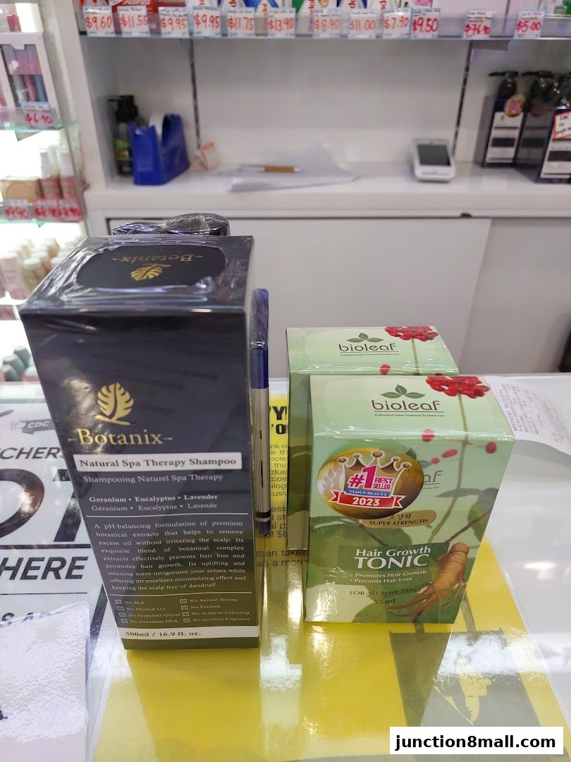Close-up of hair care products, including shampoo and hair growth tonic, on display.