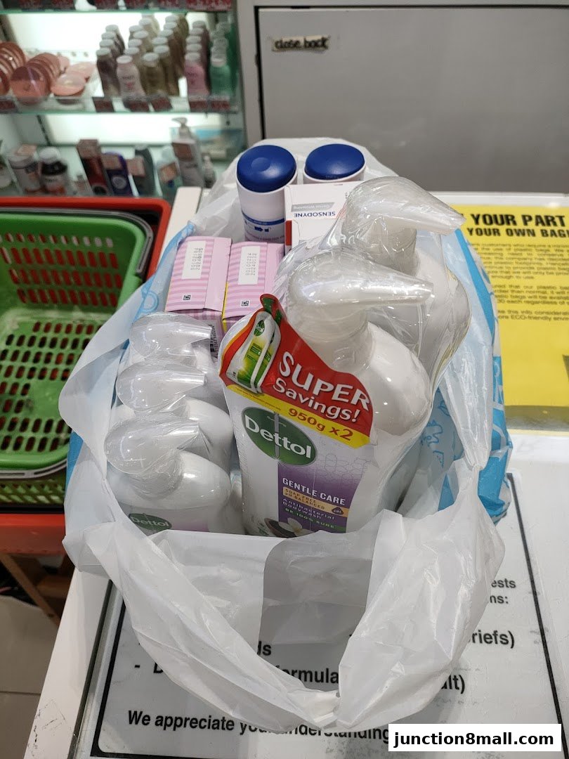 A plastic bag filled with Dettol hand wash and other personal care items.