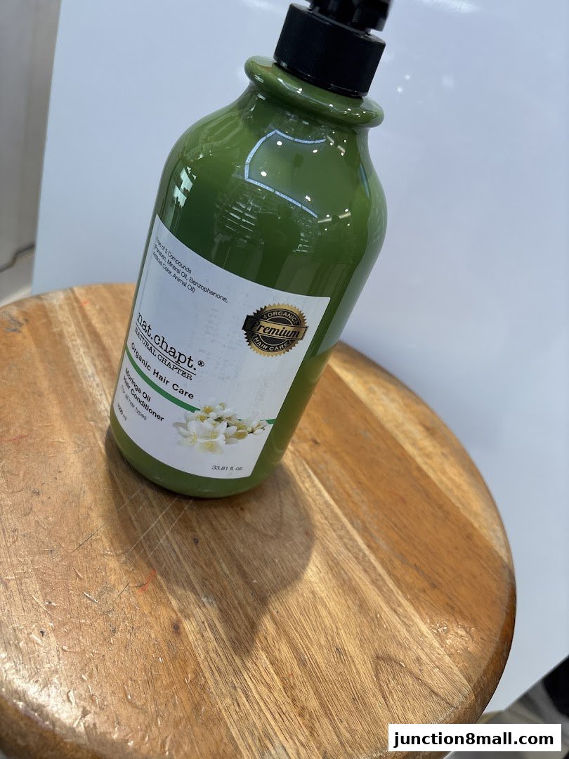 A green bottle of Nat. Chapt. Organic Hair Care Moringa Oil Hair Conditioner.