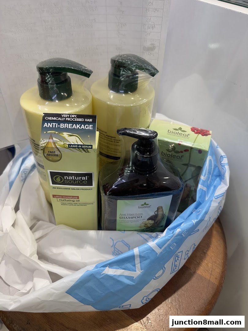 A shopping bag filled with various hair care products, including shampoos and serums.