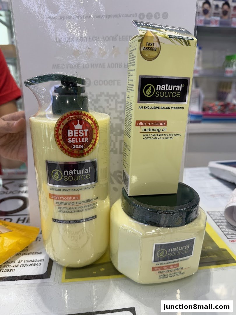 A display of 'Natural Source' hair care products, including conditioner, oil, and creme.