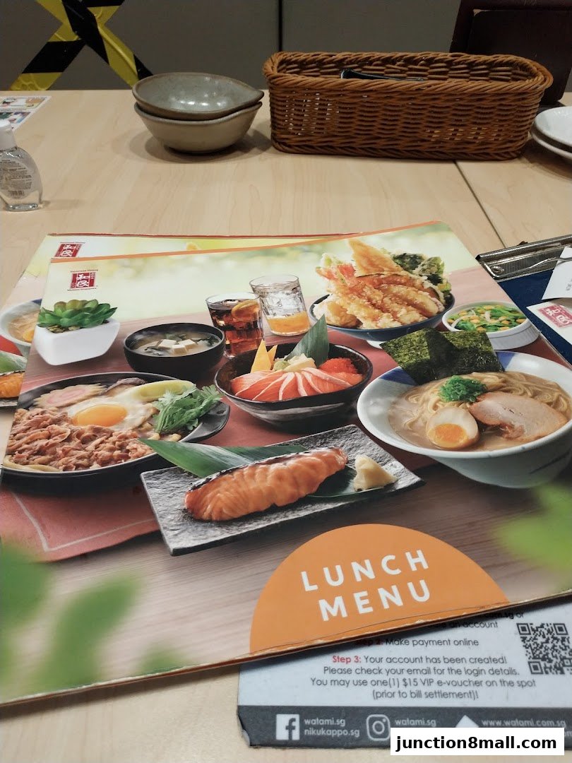 A table setting with a lunch menu featuring various Japanese dishes and a basket.