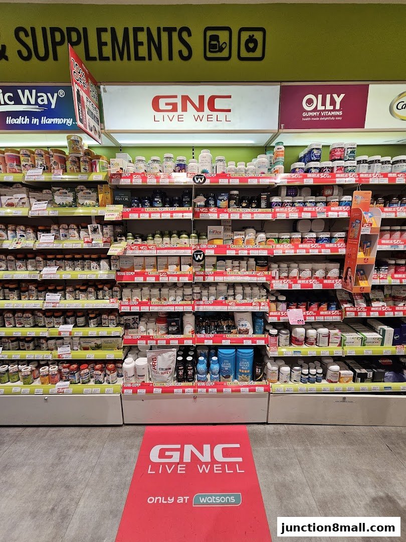Shelves stocked with various health supplements and vitamins, with GNC and Olly branding visible.