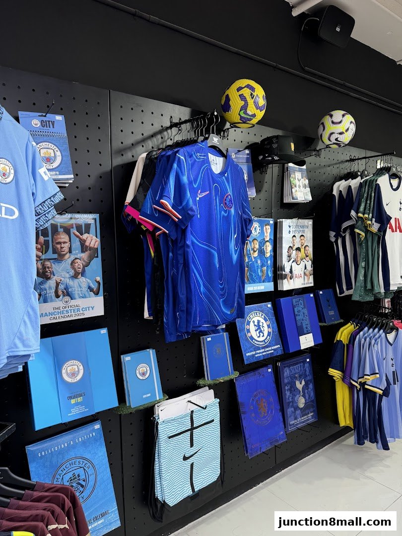 A retail display featuring football team merchandise, including jerseys, calendars, and gift sets.
