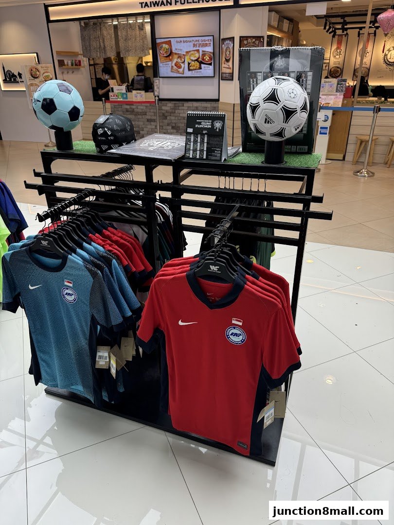 Display of soccer jerseys and footballs in a retail store.