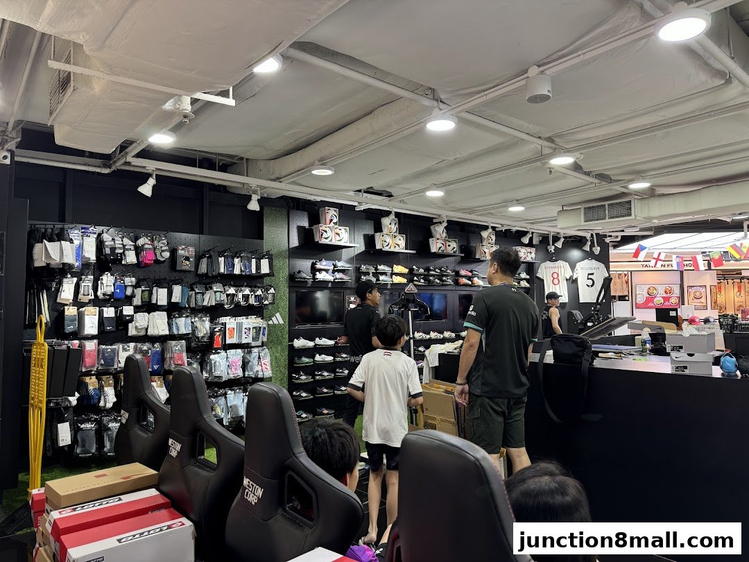 Interior of a sports apparel store with shelves stocked with socks, shoes, and jerseys.