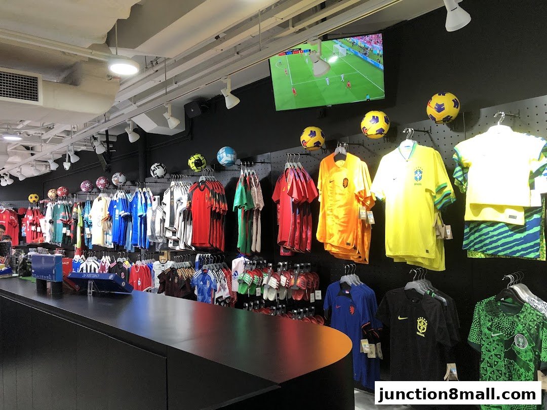 Interior of a sports apparel store showcasing various football jerseys and accessories.