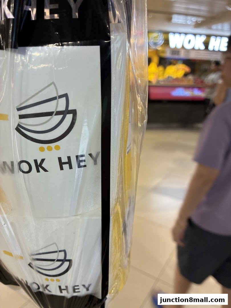 A close-up of Wok Hey packaging with the shop's logo and name visible.