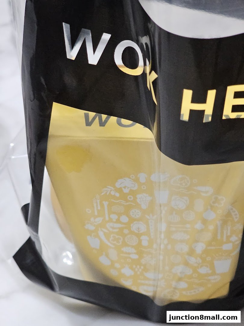 A close-up of a WOK HEY shopping bag with a graphic of vegetables.