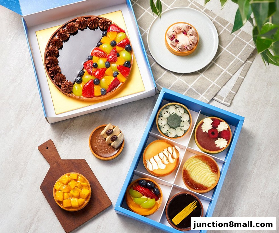 A variety of beautifully decorated tarts, including a large fruit tart and a selection of mini tarts.