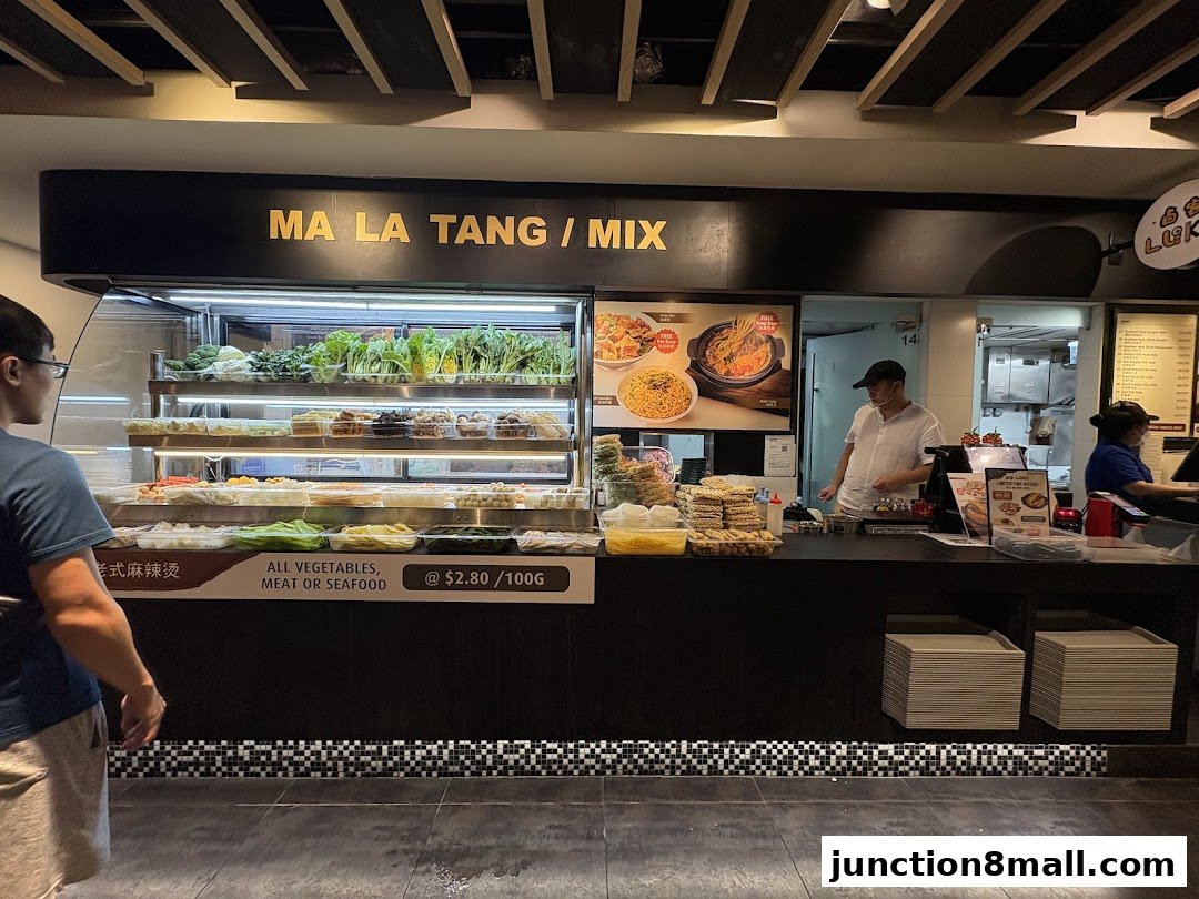 A customer views a selection of fresh ingredients at a Mala Tang stall.