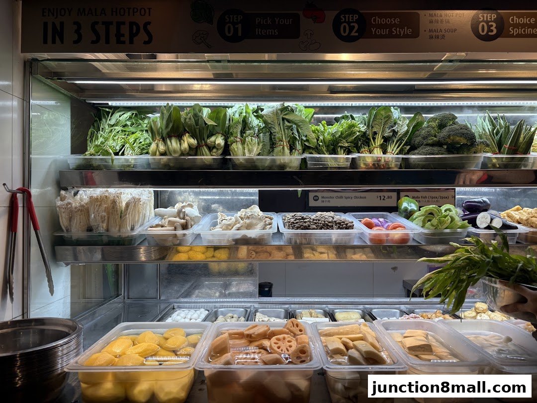 A display of fresh ingredients for Mala Hot Pot, including vegetables, mushrooms, and tofu.