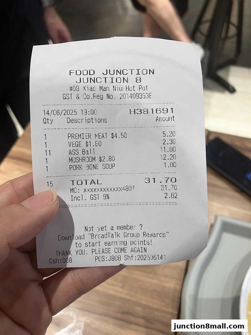 A receipt from Xiao Man Niu Mala Hot Pot showing purchased items and total cost.