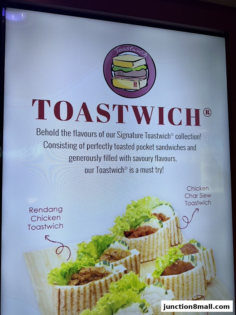 A display showcasing Ya Kun Kaya Toast's signature Toastwich sandwiches with various fillings.