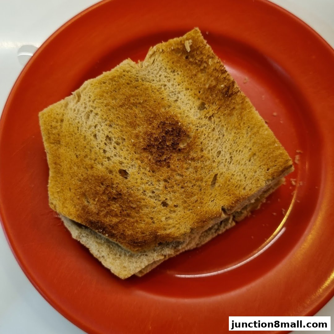 A close-up shot of kaya toast on a red plate.