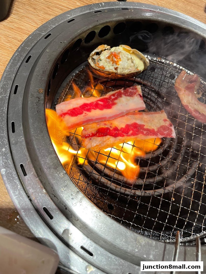 Sizzling beef and seafood are grilled over open flames in a Yakiniku Like restaurant.