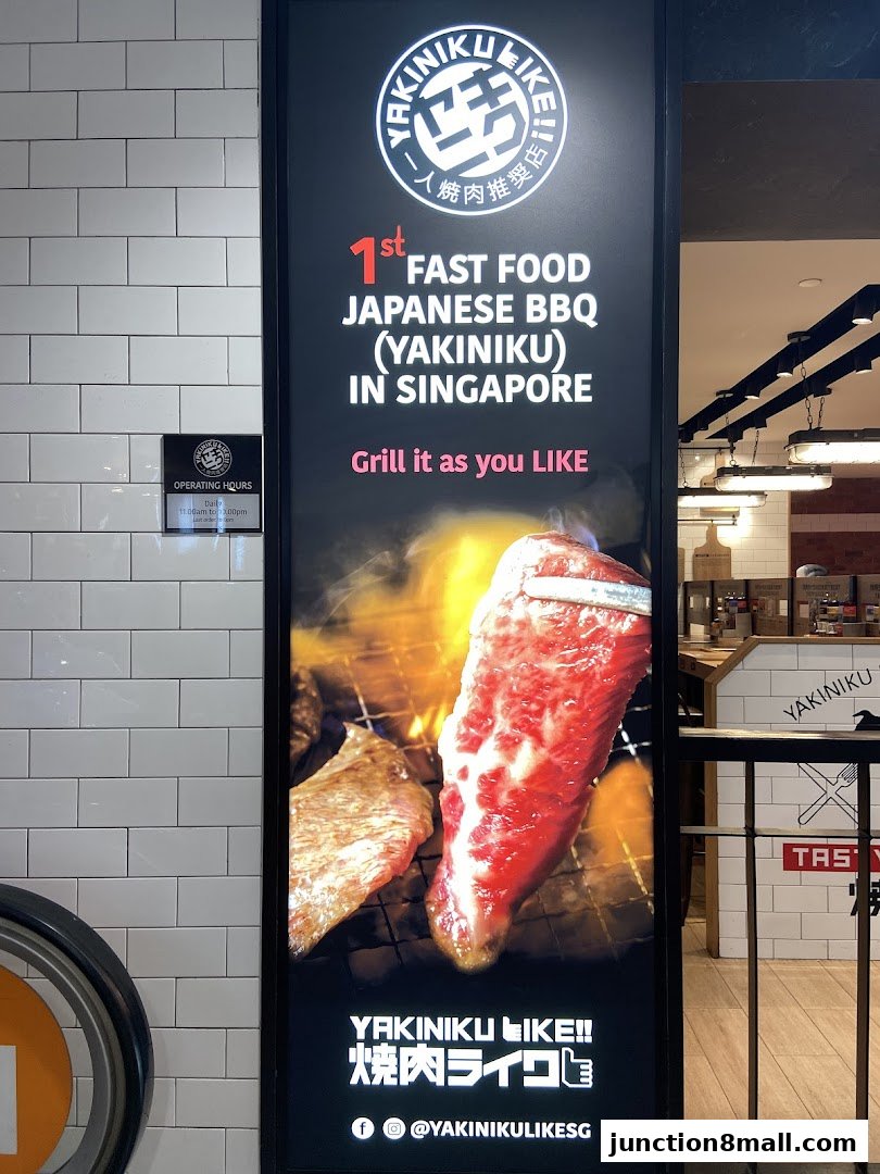 A sign for Yakiniku Like, advertising fast food Japanese BBQ with a picture of grilling meat.