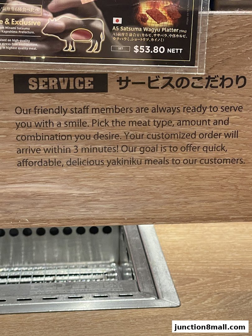 A sign detailing the service philosophy and a Wagyu platter at Yakiniku Like.