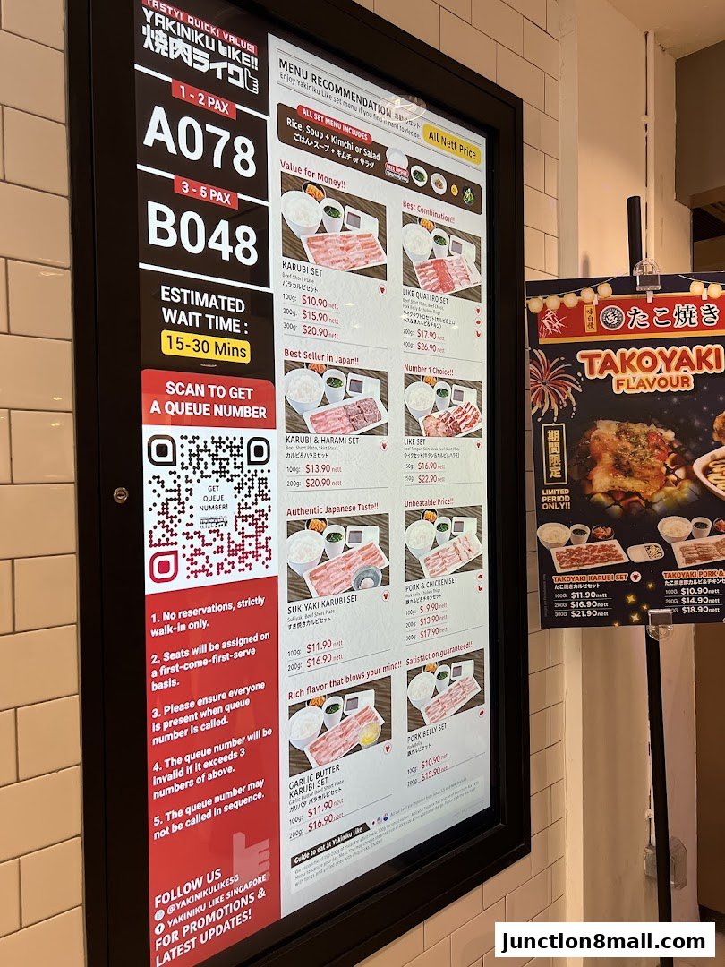 A digital menu board displaying various Yakiniku sets with prices and descriptions.