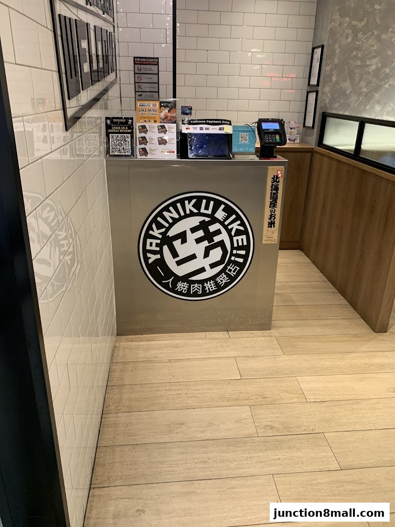 The counter area of Yakiniku Like Junction 8 with a logo and payment terminals.