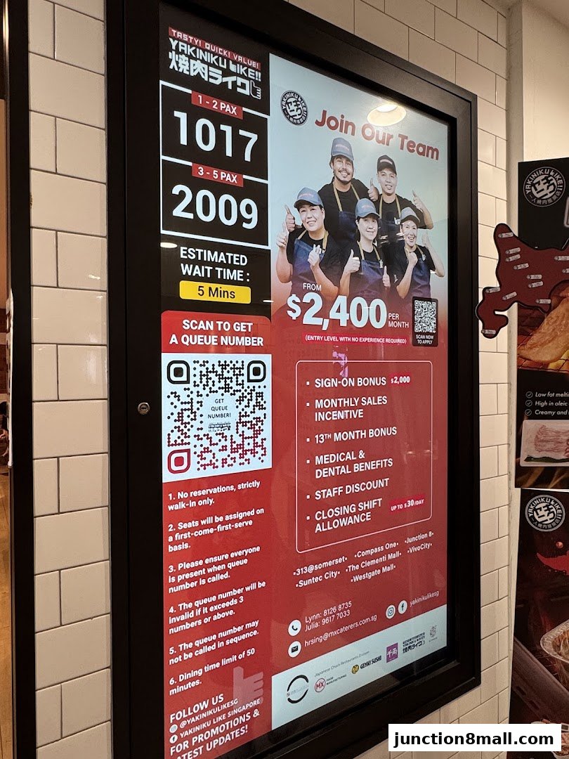 A digital display board showing queue numbers, estimated wait time, and a recruitment advertisement.