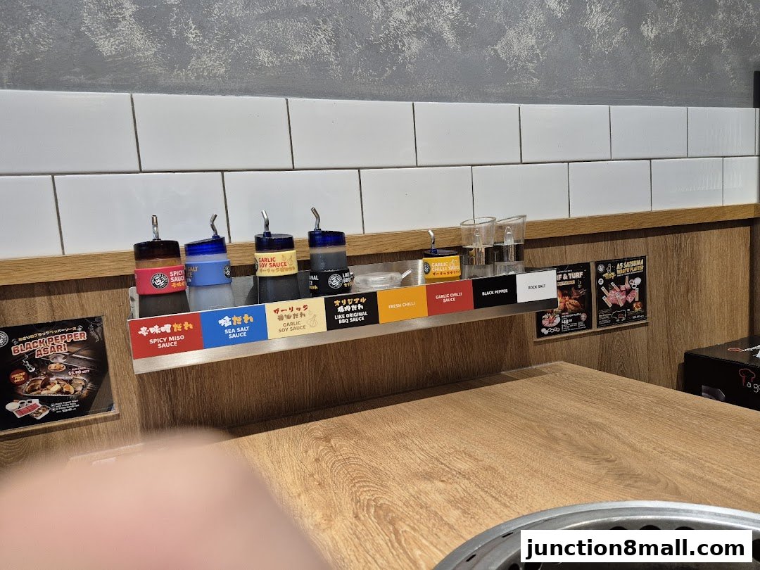 Condiment station with various sauces and seasonings at Yakiniku Like.