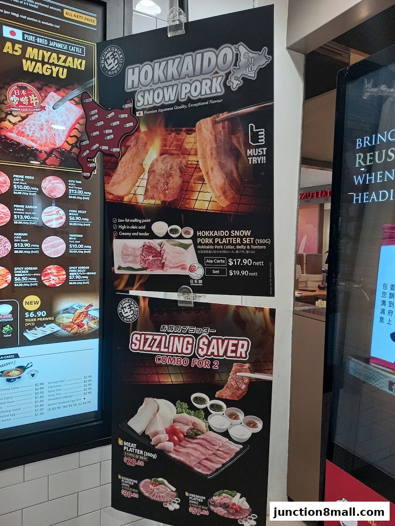 A display of Yakiniku Like Junction 8's menu featuring Hokkaido Snow Pork and Sizzling Saver combos.