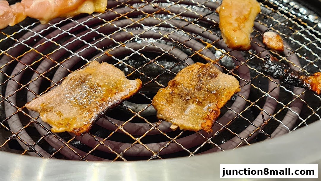 Close-up of delicious Yakiniku meat grilling on a hot electric grill.