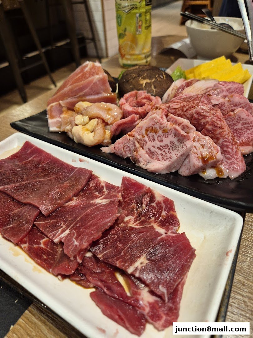 A close-up of various cuts of raw beef and pork, ready for grilling.