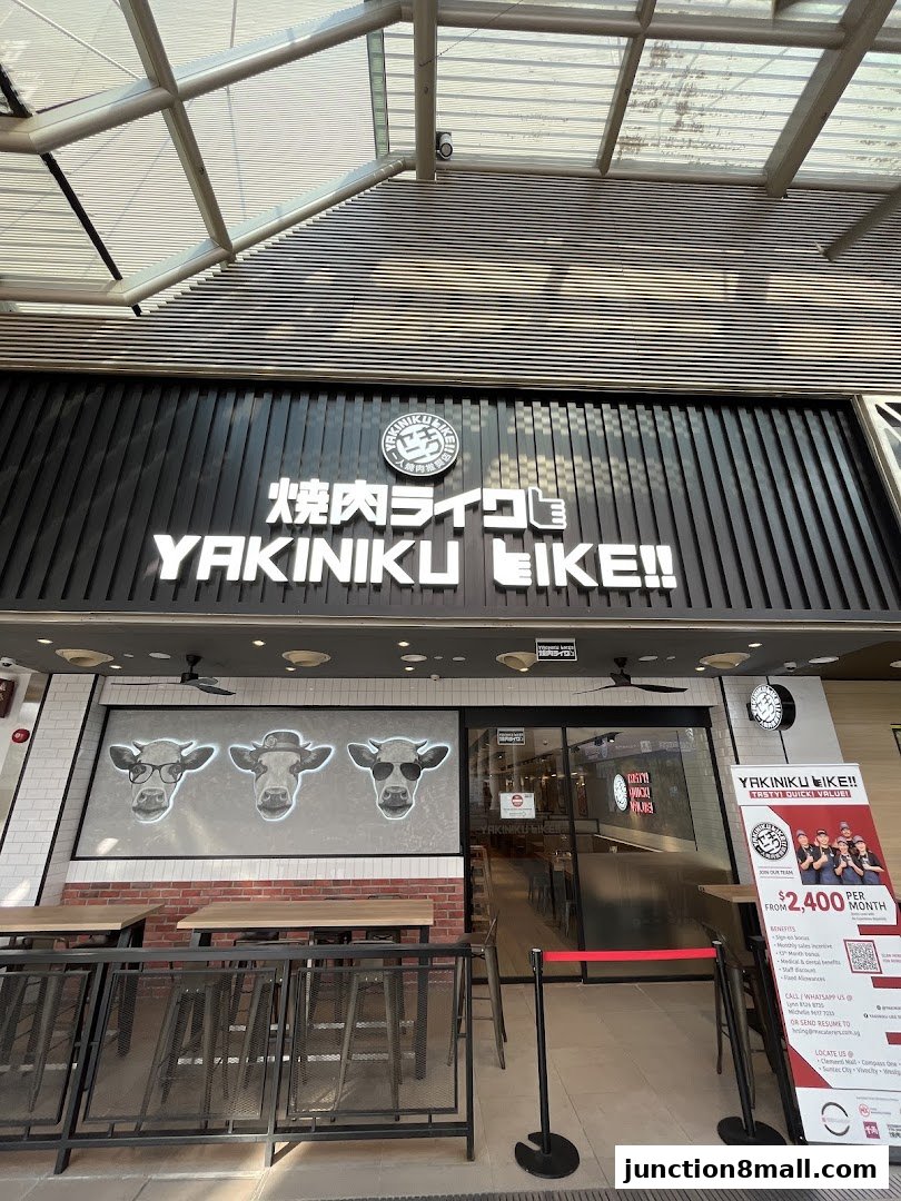 The exterior of Yakiniku Like Junction 8, featuring its prominent signage and a playful cow graphic.
