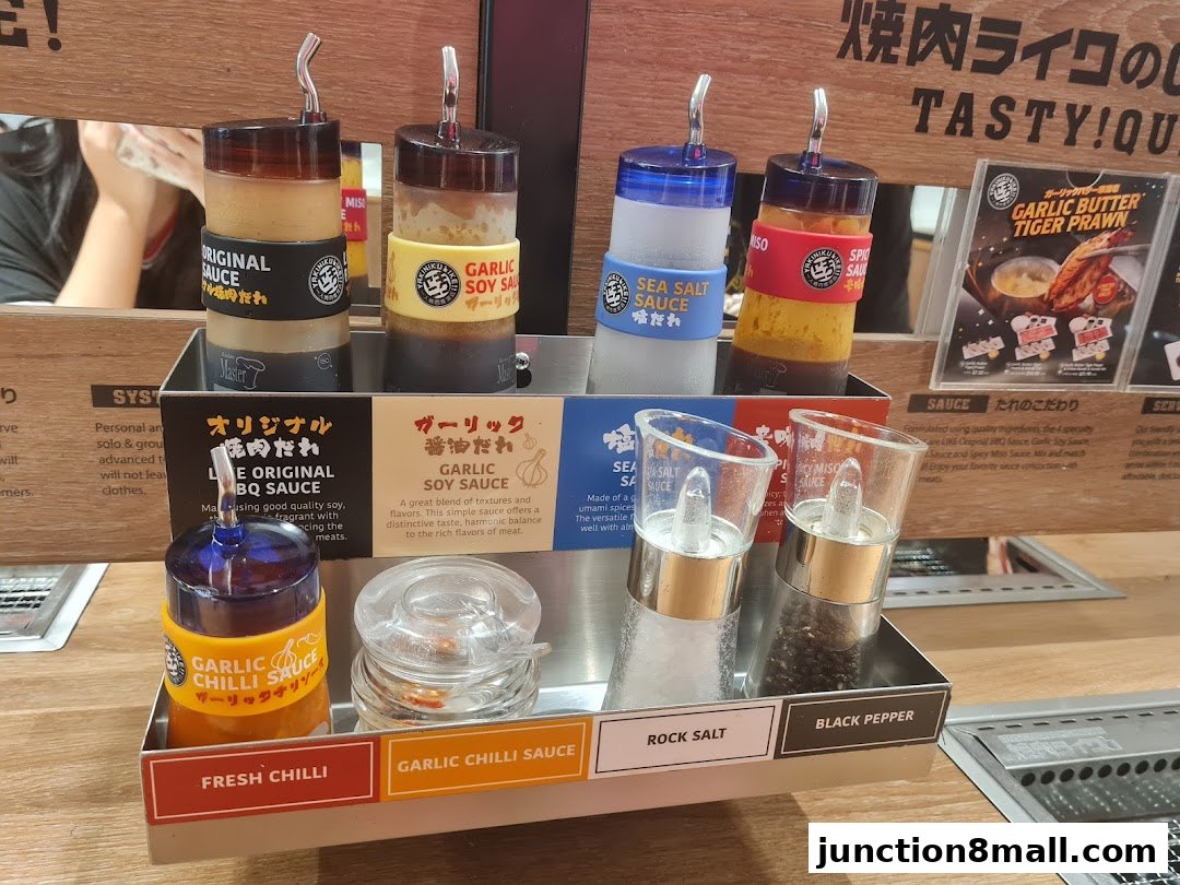 A selection of sauces and seasonings for yakiniku, including BBQ sauce, soy sauce, and chili sauce.