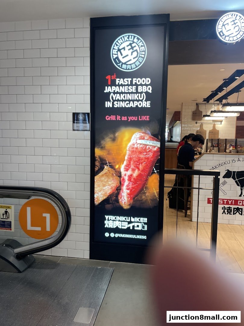 A vertical advertisement for Yakiniku Like, showcasing grilled meat and the restaurant's slogan.