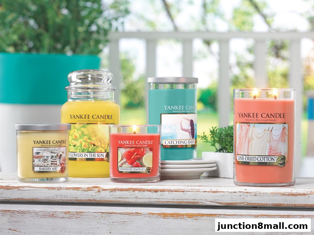 A collection of Yankee Candle jars and tumblers with various scents and designs.