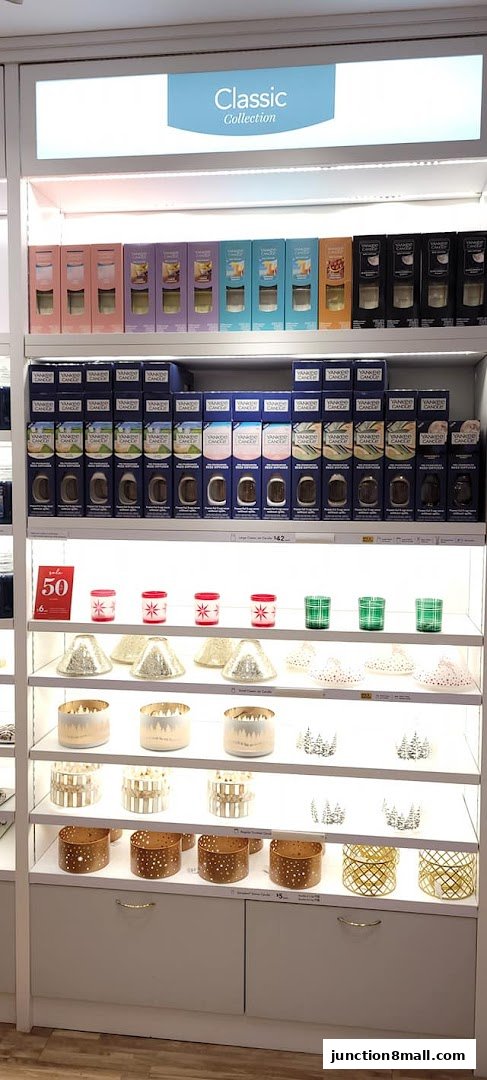 Yankee Candle store display featuring various collections of candles and accessories.