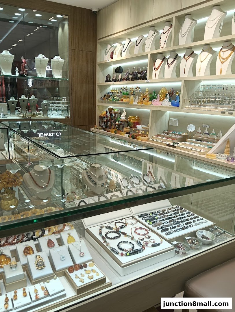 A well-lit jewelry store showcasing necklaces, bracelets, and decorative items in display cases and on shelves.