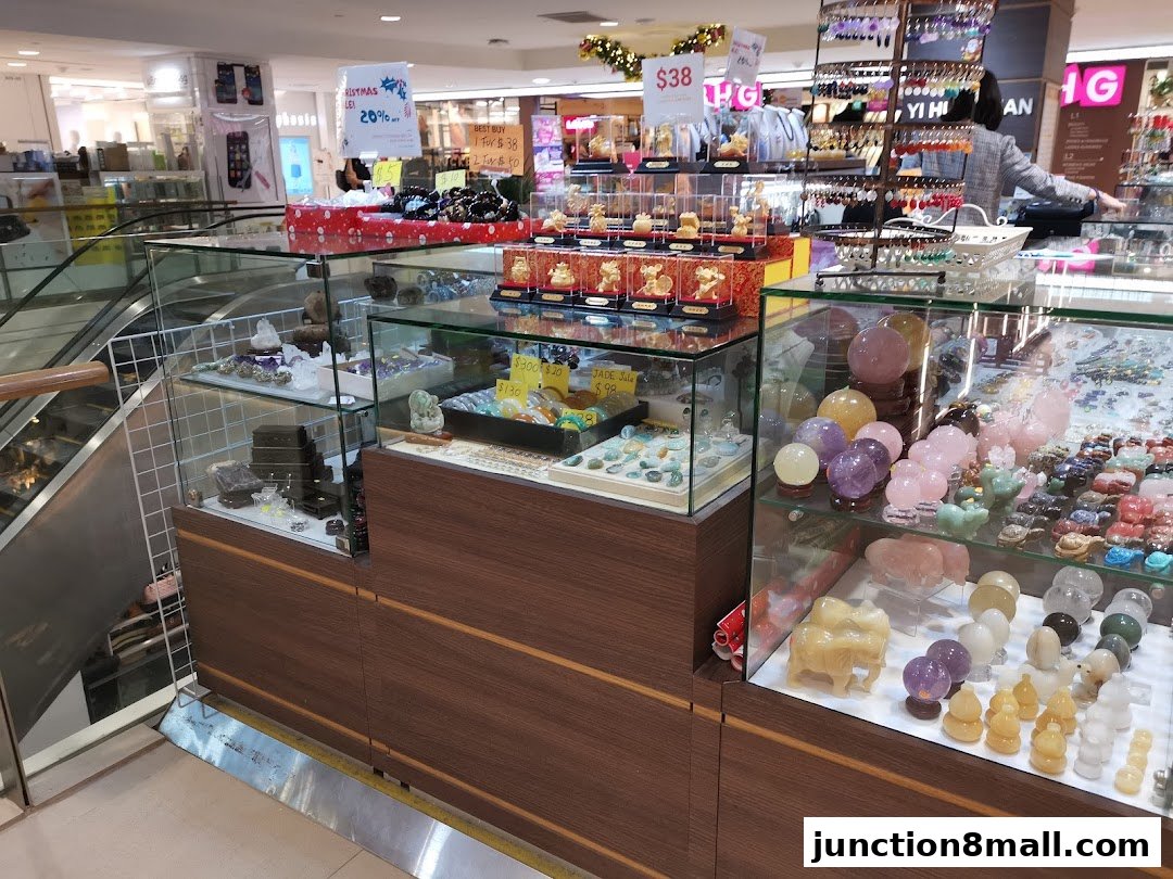 A retail display featuring various crystals, jade items, and decorative ornaments.