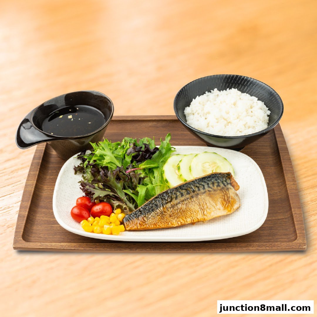 A grilled fish set meal with rice, salad, and dipping sauce on a wooden tray.