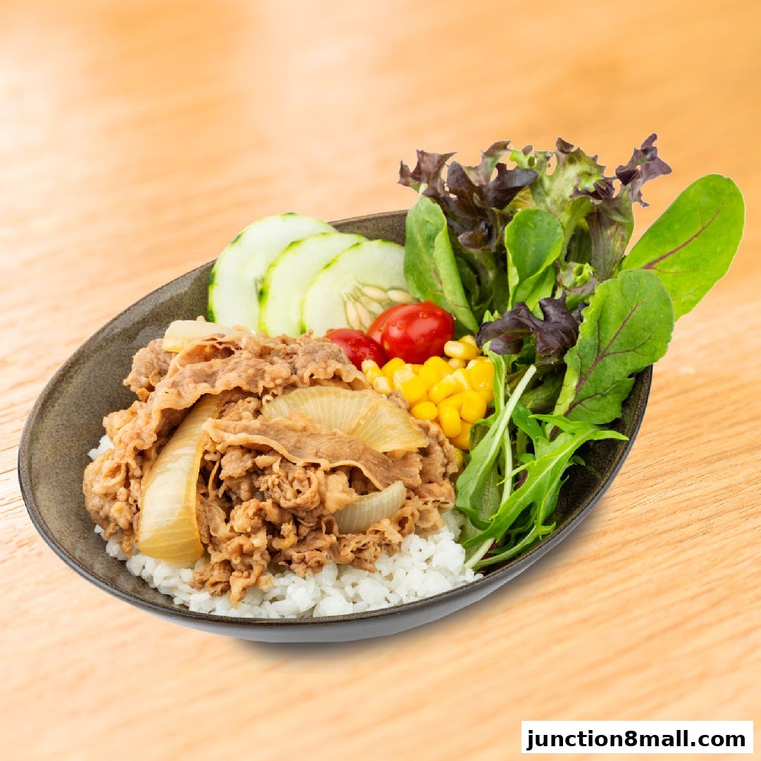A delicious Yoshinoya beef bowl with rice, salad, cucumber, and corn.