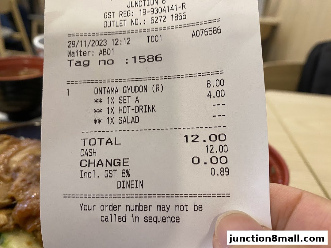 A receipt from Yoshinoya showing an order for Ontama Gyudon with a set meal, hot drink, and salad.