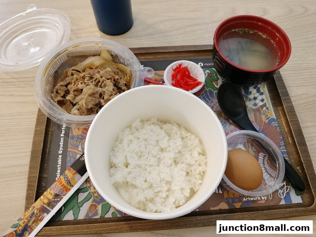 A Yoshinoya meal featuring beef bowl, rice, miso soup, pickled ginger, and a raw egg.