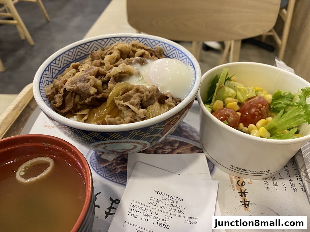 A Yoshinoya meal featuring a beef bowl, side salad, and miso soup.