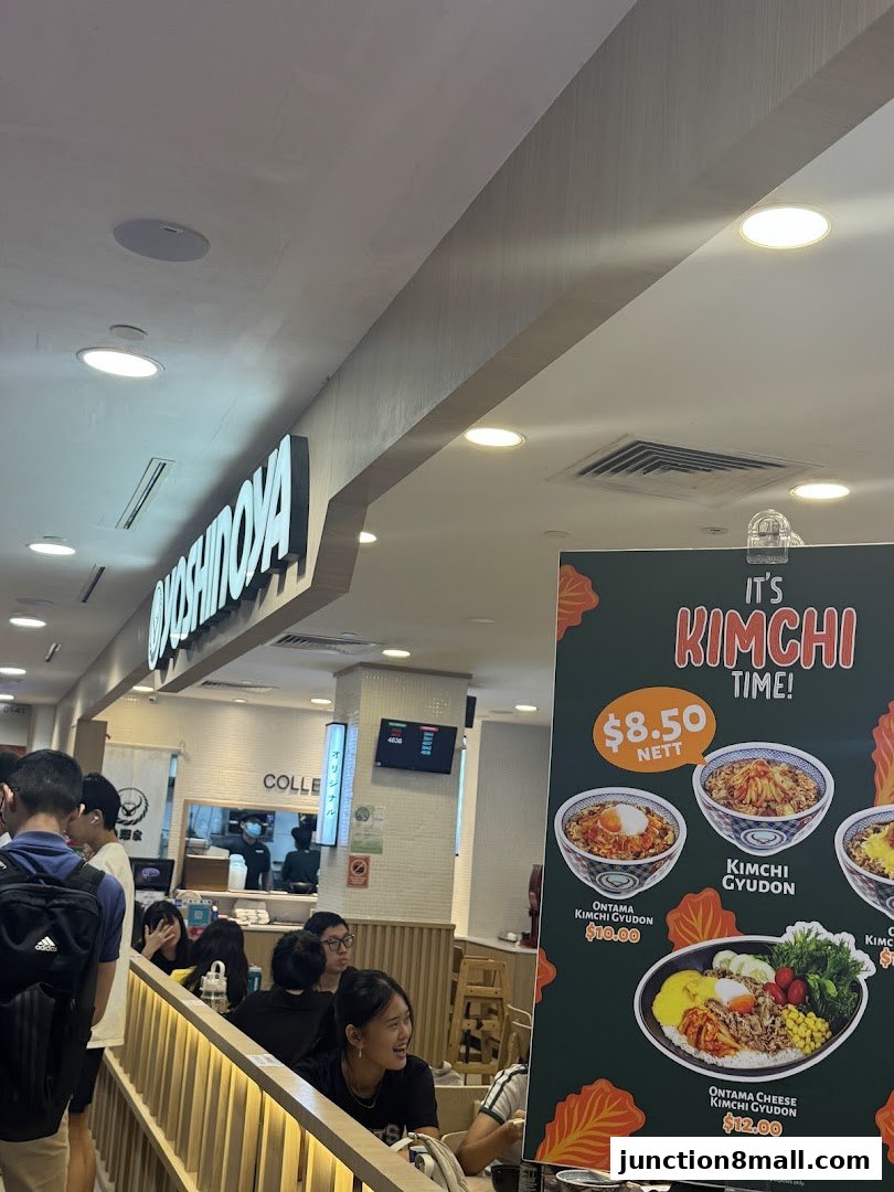 A Yoshinoya restaurant interior with a promotional poster for Kimchi dishes.