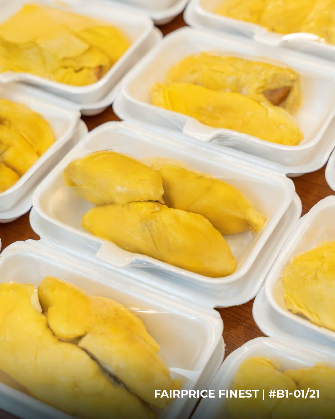 Fresh durian segments in packaged trays at FairPrice Finest Junction 8